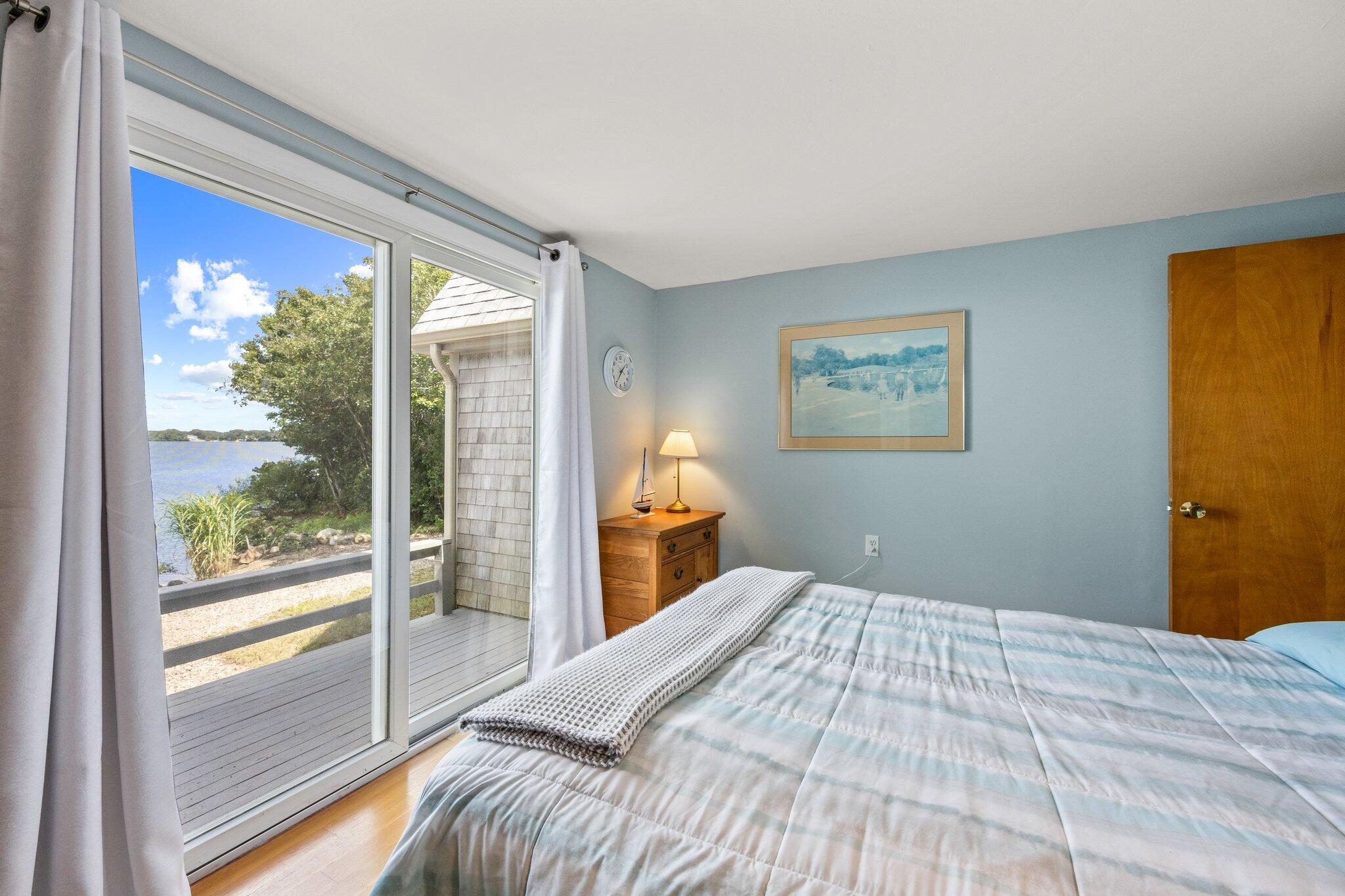 159 Willow Run Drive Centerville, MA 02632 - Photo 18 of 34 a bedroom with a bed and a large window