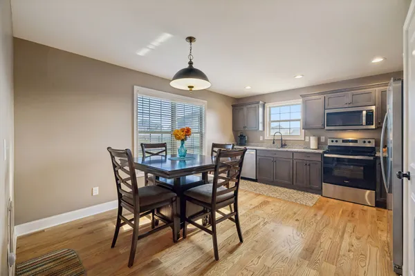 a view of a dining room with furniture and wooden floor
