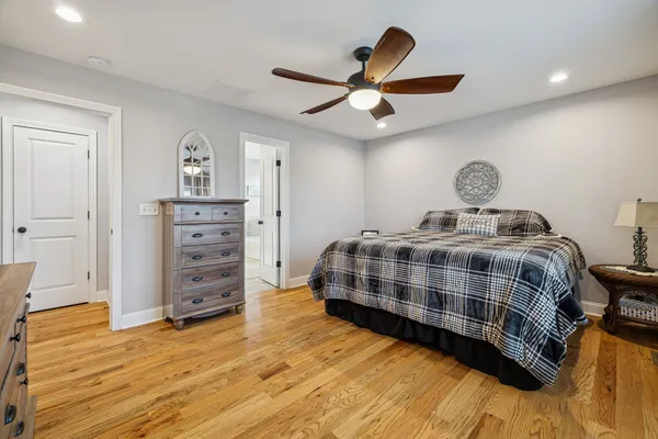 a bedroom with a bed and wooden floor