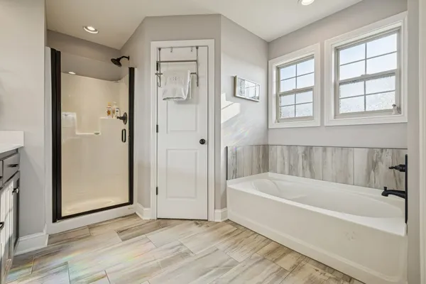 a bathroom with a bathtub and a shower