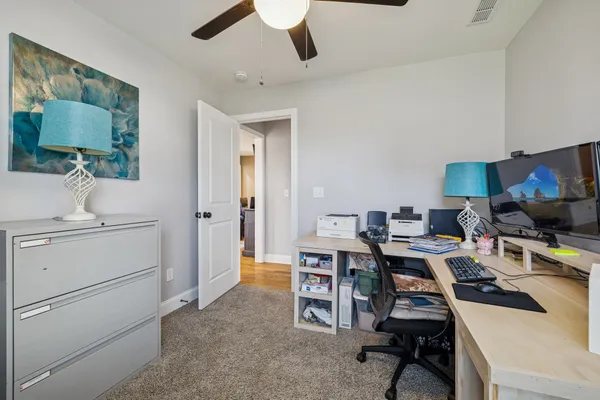 a workspace with furniture and a lamp