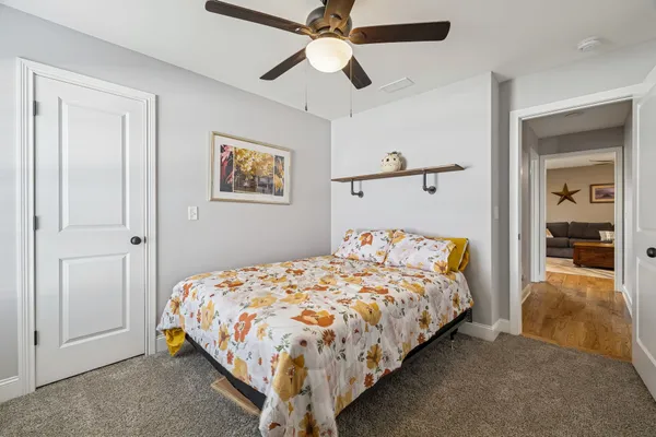 a bedroom with a bed and a chandelier
