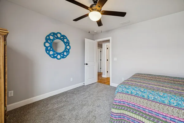 a bedroom with bed and a chandelier