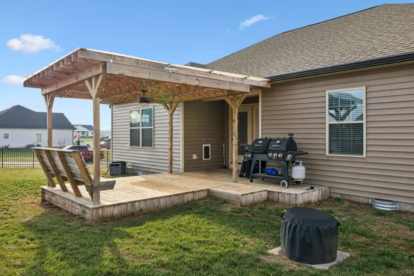 a view of a house with backyard sitting area and swimming pool