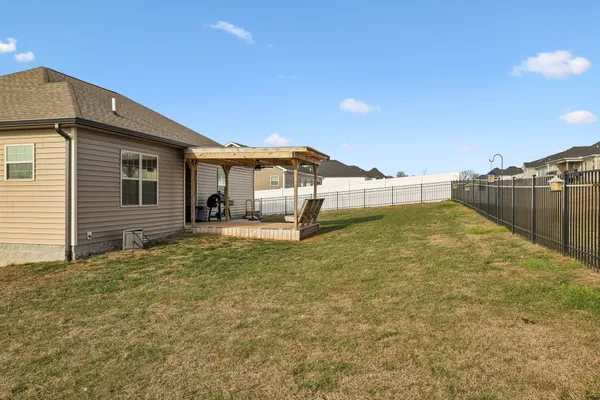 a view of a house with a backyard