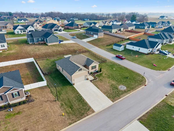 an aerial view of a house with a yard