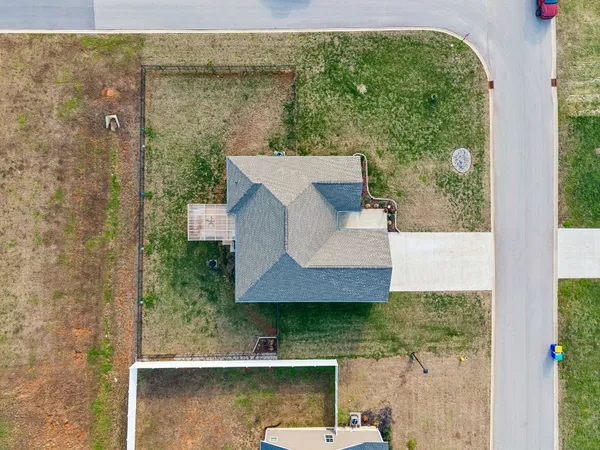 an aerial view of a house with outdoor space