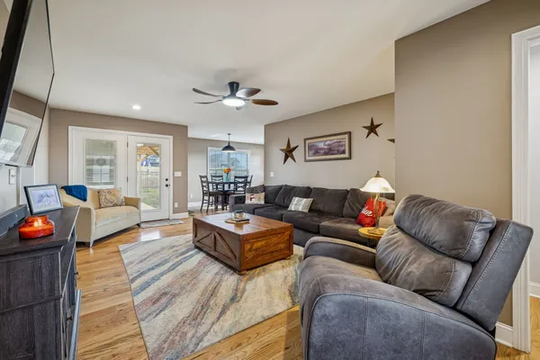 a living room with furniture and a wooden floor