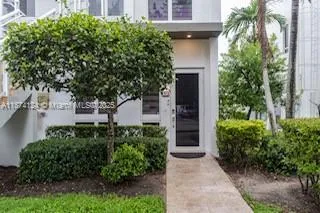 front view of a house with a tree