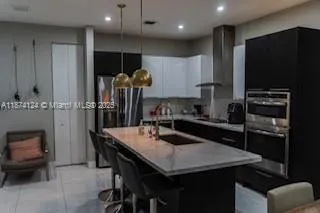 a kitchen with a table chairs sink and stove