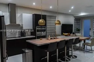 a kitchen with stainless steel appliances a sink stove and cabinets