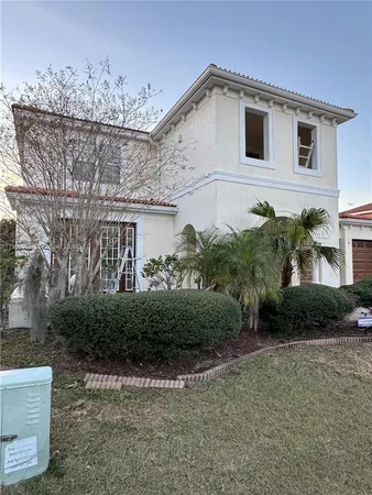 a view of a house with backyard and porch
