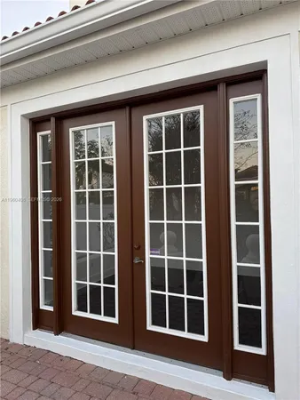 a kitchen with granite countertop white cabinets and stainless steel appliances
