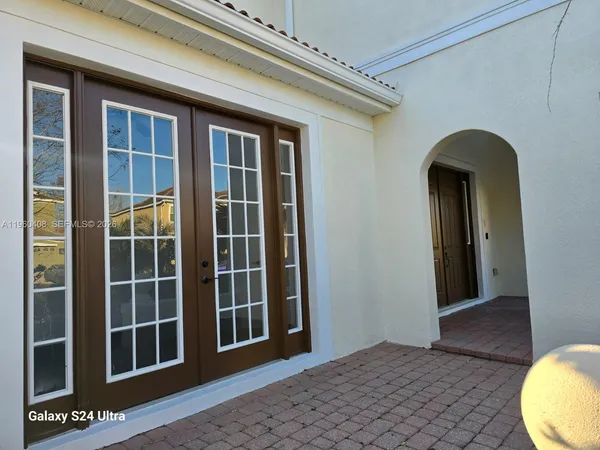 a view of a room with a ceiling fan and window