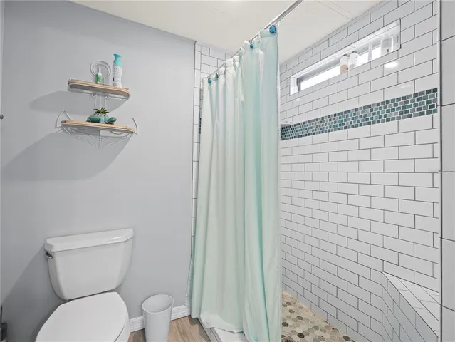 a bedroom with two beds and wooden floor