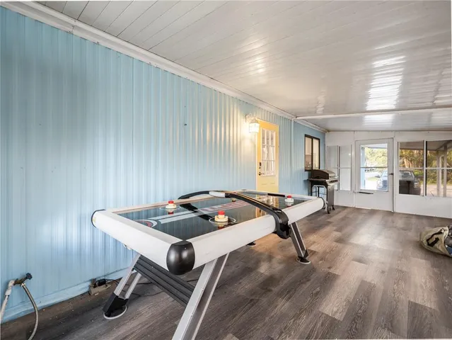 a view of a room with furniture wooden floor and windows