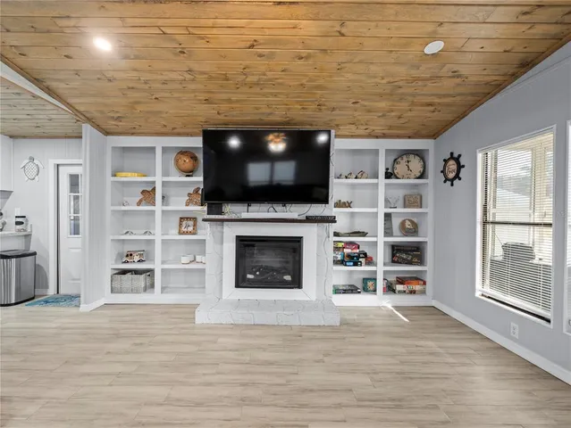 a living room with a flat screen tv and a fireplace