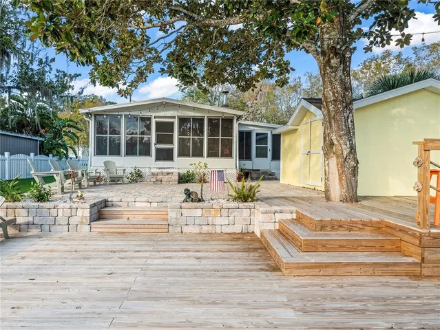 a view of a backyard with sitting area