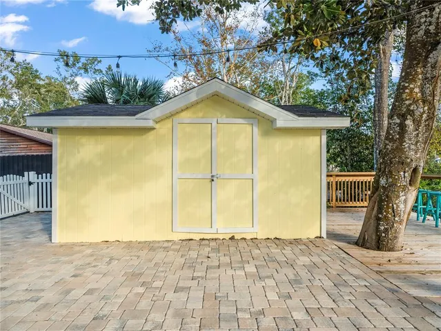 a view of a park with potted plants and large tree