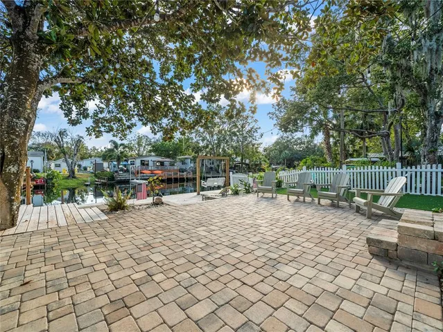 a view of a house with backyard sitting area and garden