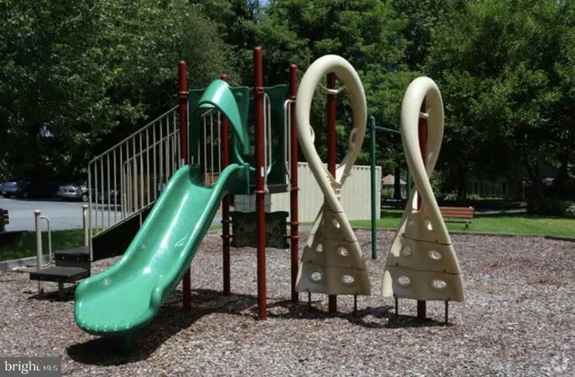 a childrens park with lots of green space and plants