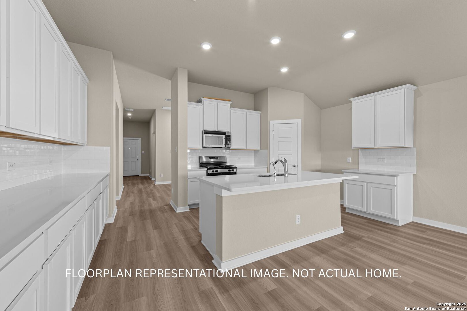 1177 Limestone Ridge Seguin, TX 78155 - Photo 15 of 40 a large white kitchen with kitchen island a sink a stove a refrigerator and white cabinets