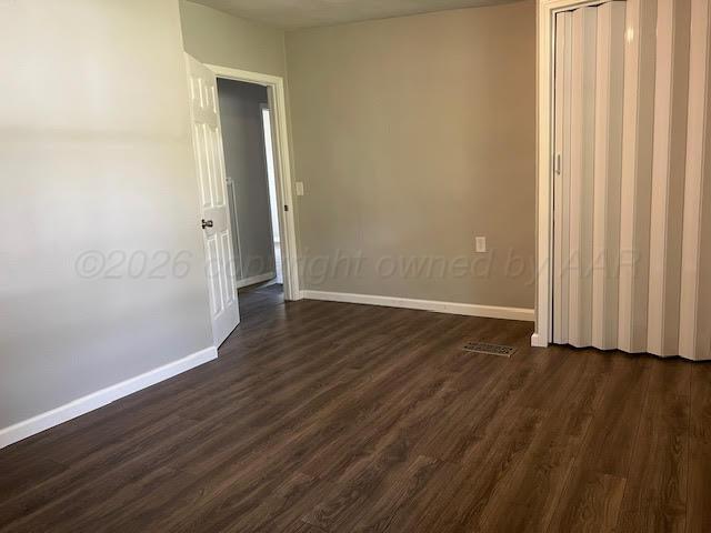 530 South Main Street Booker, TX 79005 - Photo 5 of 10 a view of an empty room with wooden floor and a window