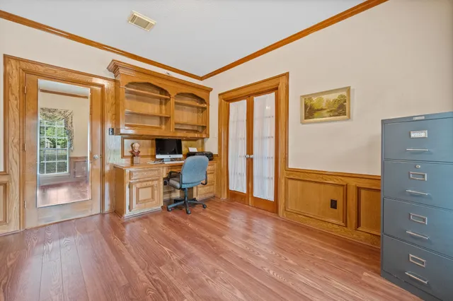 a view of a workspace with furniture and a window