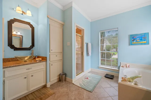 a bedroom with a bed and a mirror on the dresser