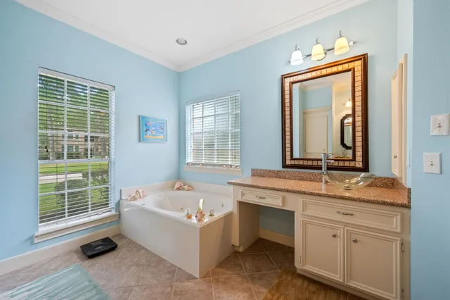 a bathroom with a tub sink and mirror