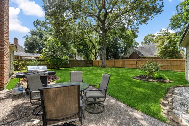 a view of a table and chairs in the garden