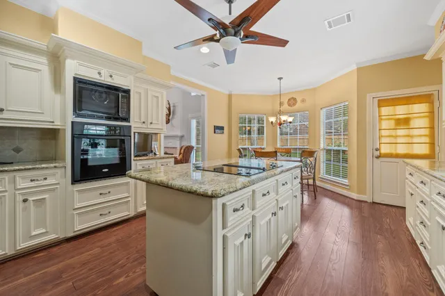 a kitchen with stainless steel appliances granite countertop a stove and cabinets