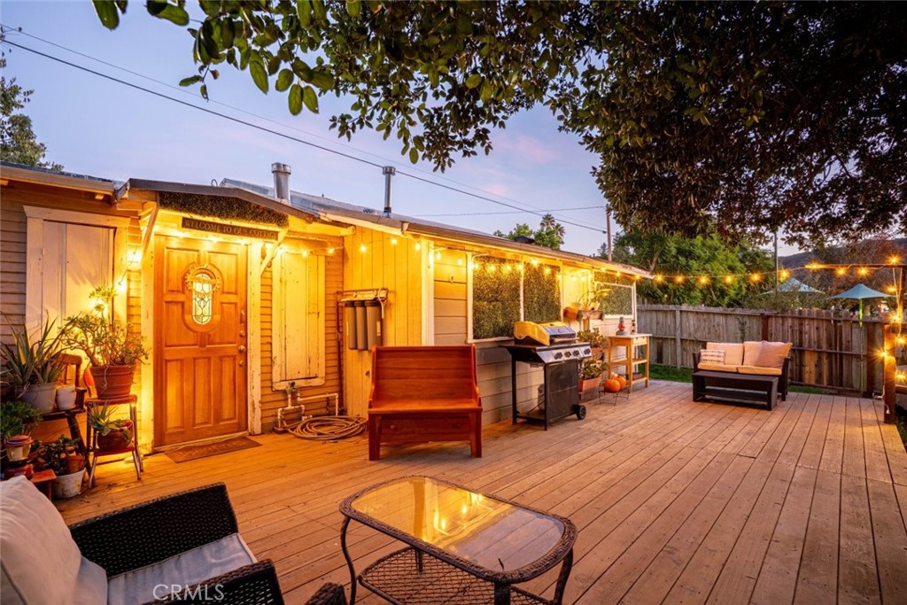 a view of a living room with furniture and wooden floor