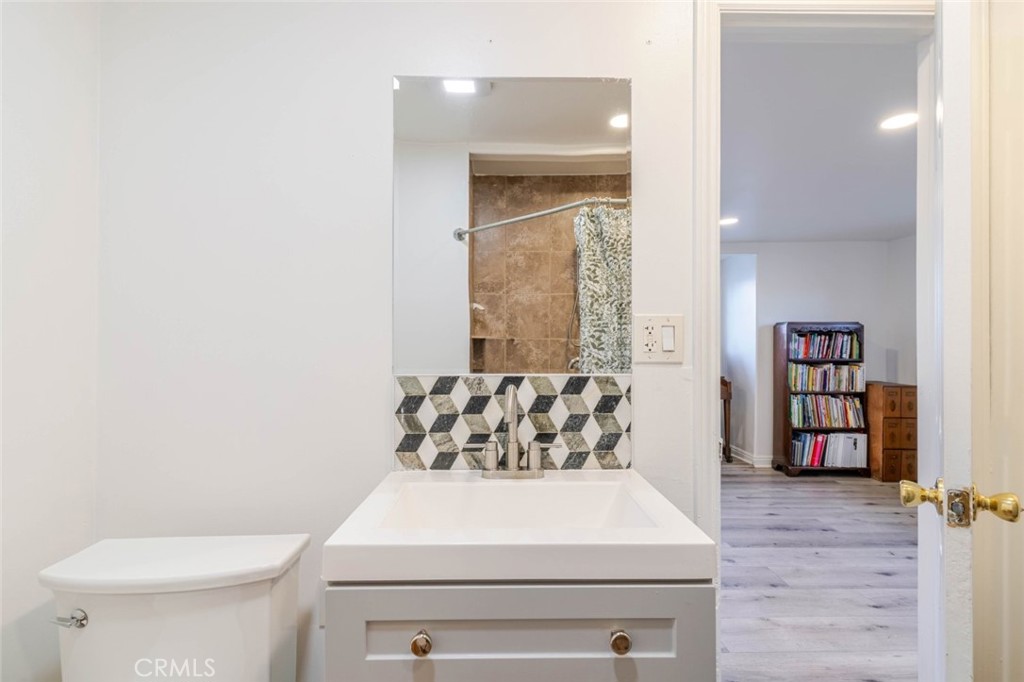 10434 Irma Avenue Tujunga, CA 91042 - Photo 14 of 29 a bathroom with a toilet sink and a window