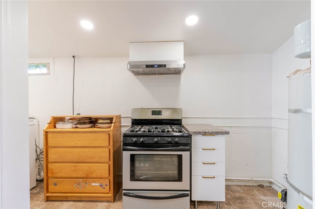 10434 Irma Avenue Tujunga, CA 91042 - Photo 5 of 29 a kitchen with a stove and a cabinet