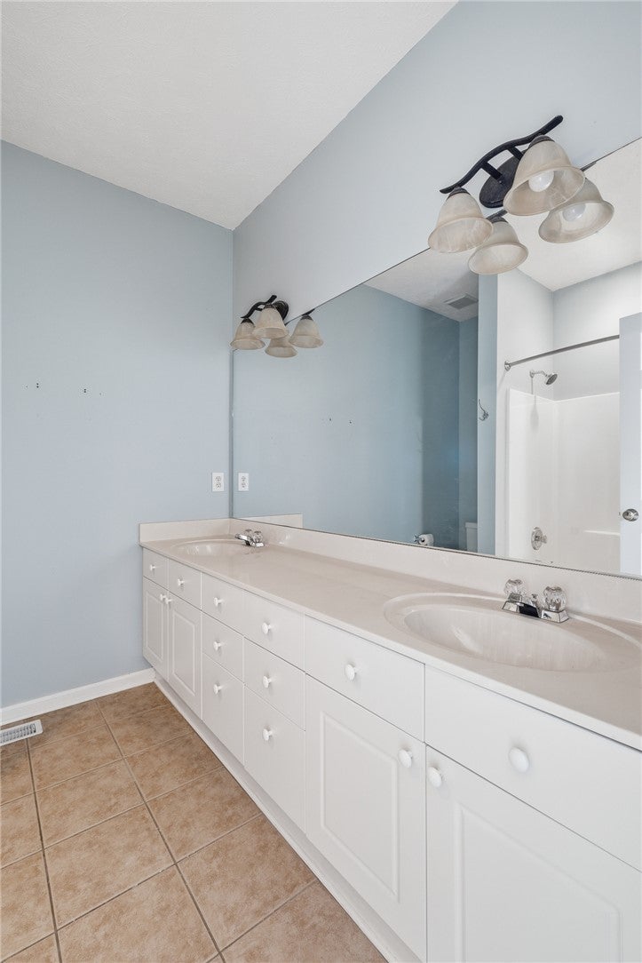 1213 North Dean Road Auburn, AL 36830 - Photo 12 of 18 This primary bathroom offers dual sinks, ample storage, and a shower for everyday convenience.