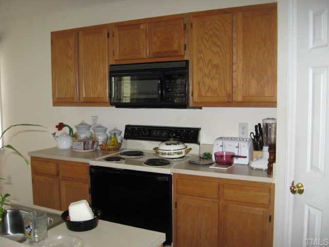11113 North Radner Way Raleigh, NC 27613 - Photo 6 of 10 kitchen is open to family room and has microwave