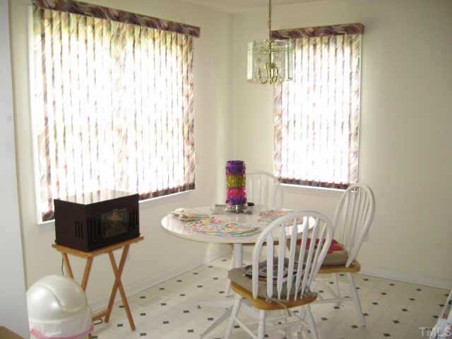 11113 North Radner Way Raleigh, NC 27613 - Photo 7 of 10 breakfast area is sunny and bright and has door leading to deck