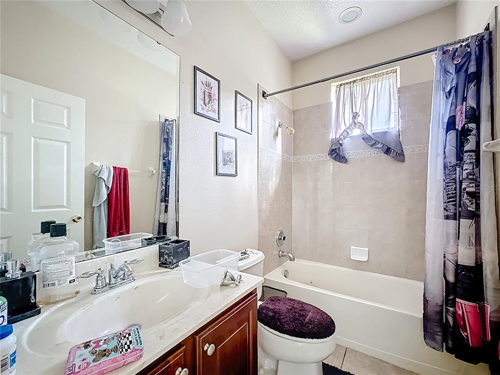 1692 Scrub Jay Road Apopka, FL 32703 - Photo 12 of 35 a bathroom with a sink a toilet and a bathtub