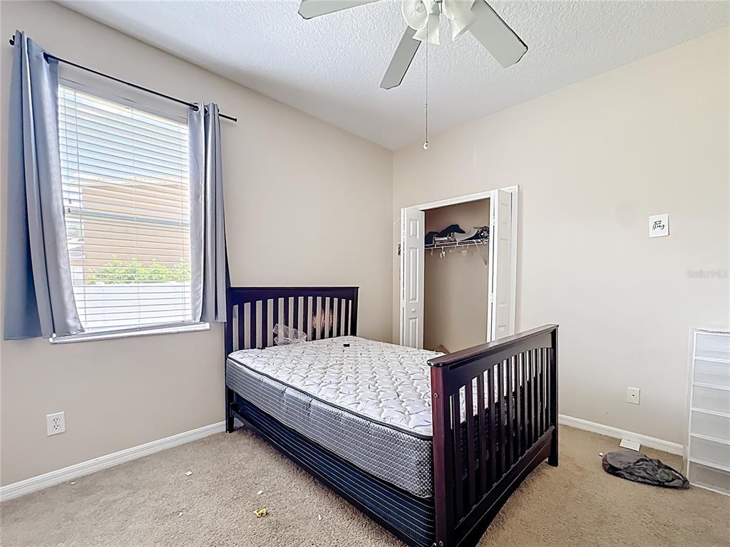 1692 Scrub Jay Road Apopka, FL 32703 - Photo 13 of 35 a view of a bedroom with furniture