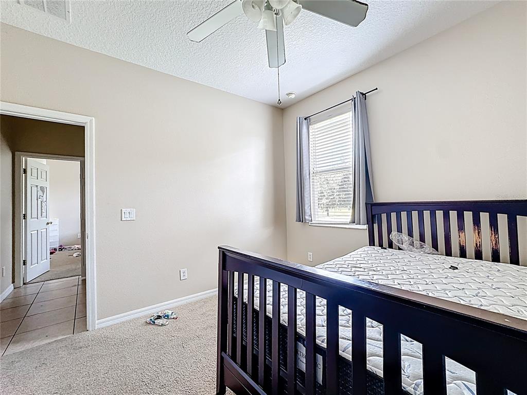 1692 Scrub Jay Road Apopka, FL 32703 - Photo 14 of 35 a view of a bedroom with furniture and windows