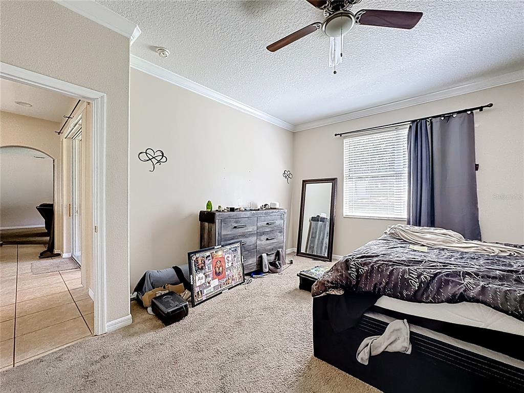 1692 Scrub Jay Road Apopka, FL 32703 - Photo 15 of 35 a bedroom with a bed and a ceiling fan