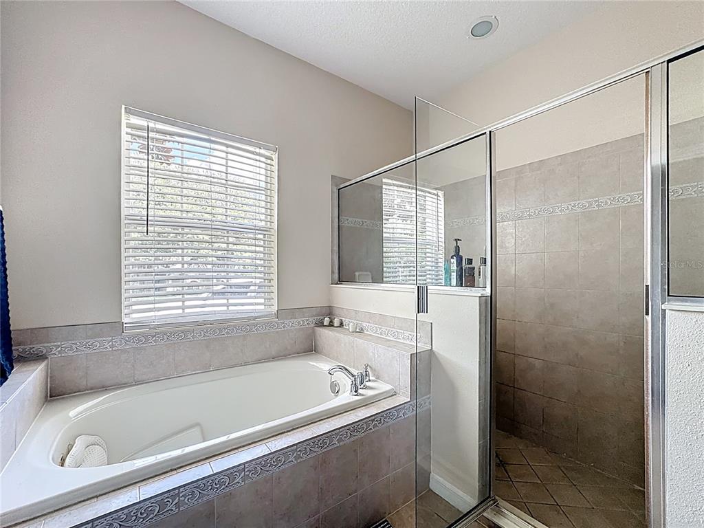 1692 Scrub Jay Road Apopka, FL 32703 - Photo 16 of 35 a white bath tub sitting next to a shower