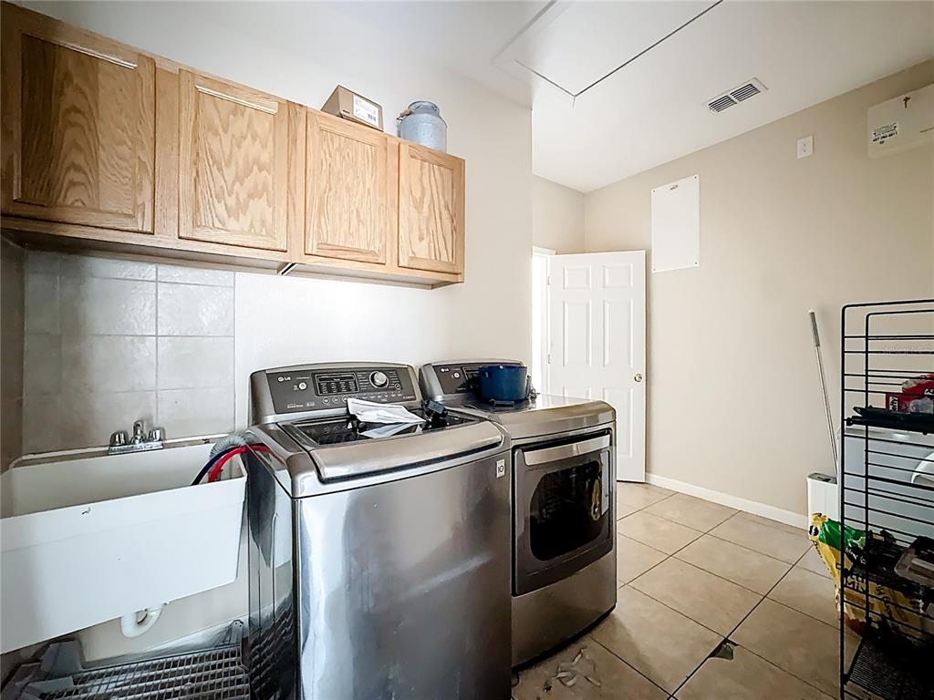 1692 Scrub Jay Road Apopka, FL 32703 - Photo 17 of 35 a kitchen with stainless steel appliances granite countertop a sink stove and cabinets