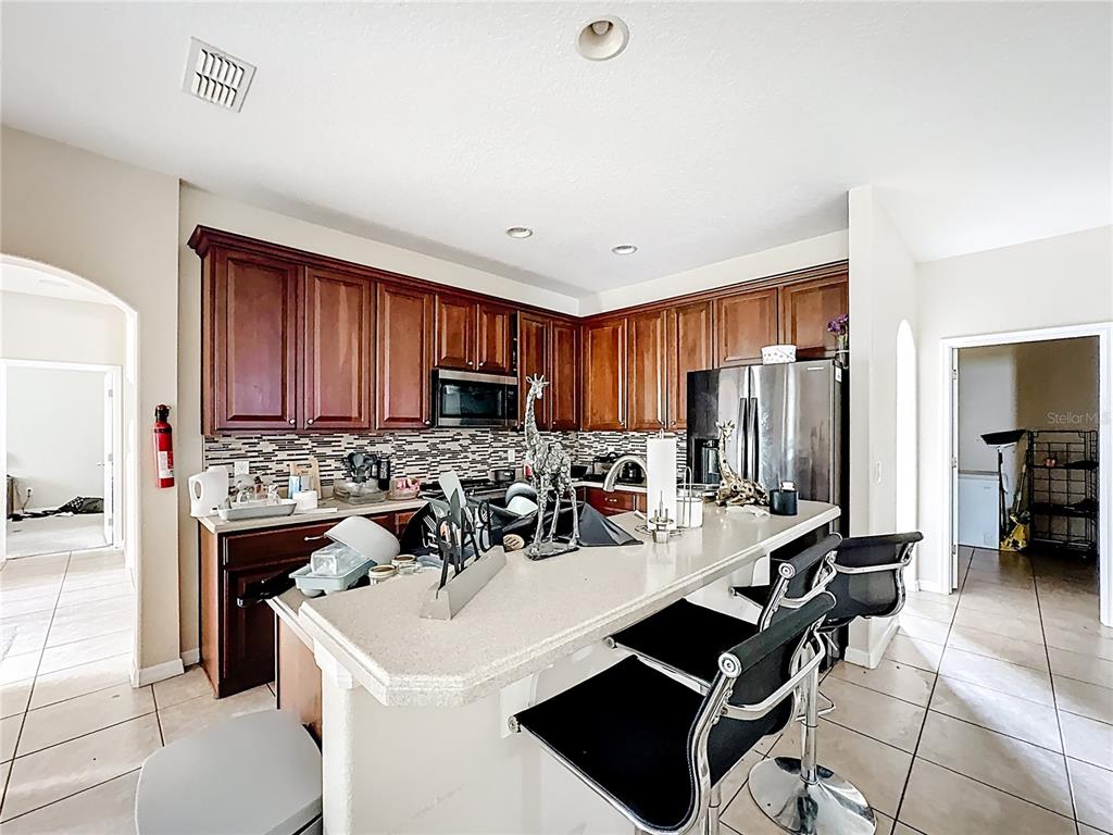 1692 Scrub Jay Road Apopka, FL 32703 - Photo 23 of 35 a view of kitchen dining table and chairs