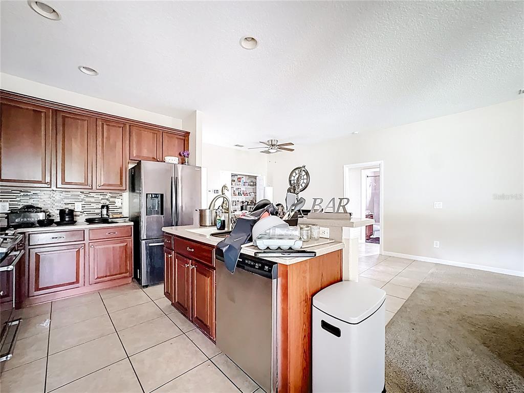 1692 Scrub Jay Road Apopka, FL 32703 - Photo 24 of 35 a kitchen with a stove top oven sink and cabinets