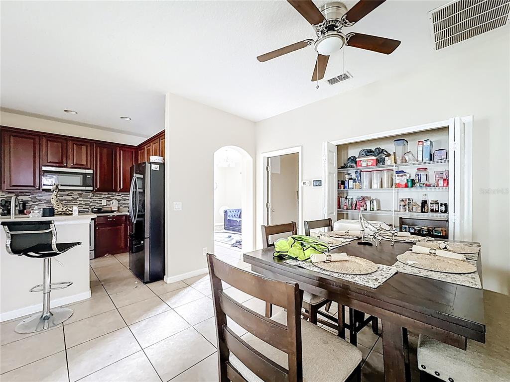 1692 Scrub Jay Road Apopka, FL 32703 - Photo 25 of 35 a view of a dining room with furniture