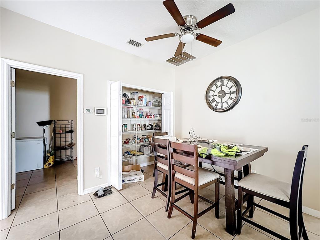 1692 Scrub Jay Road Apopka, FL 32703 - Photo 26 of 35 a view of a dining room with furniture and a table & chairs