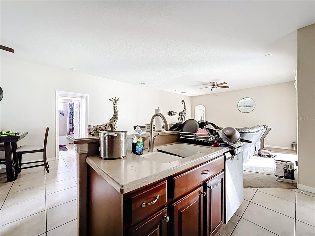 1692 Scrub Jay Road Apopka, FL 32703 - Photo 27 of 35 a kitchen with a stove and a sink