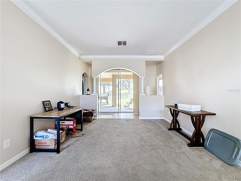 1692 Scrub Jay Road Apopka, FL 32703 - Photo 29 of 35 a view of a room that has a bed and a chair in it